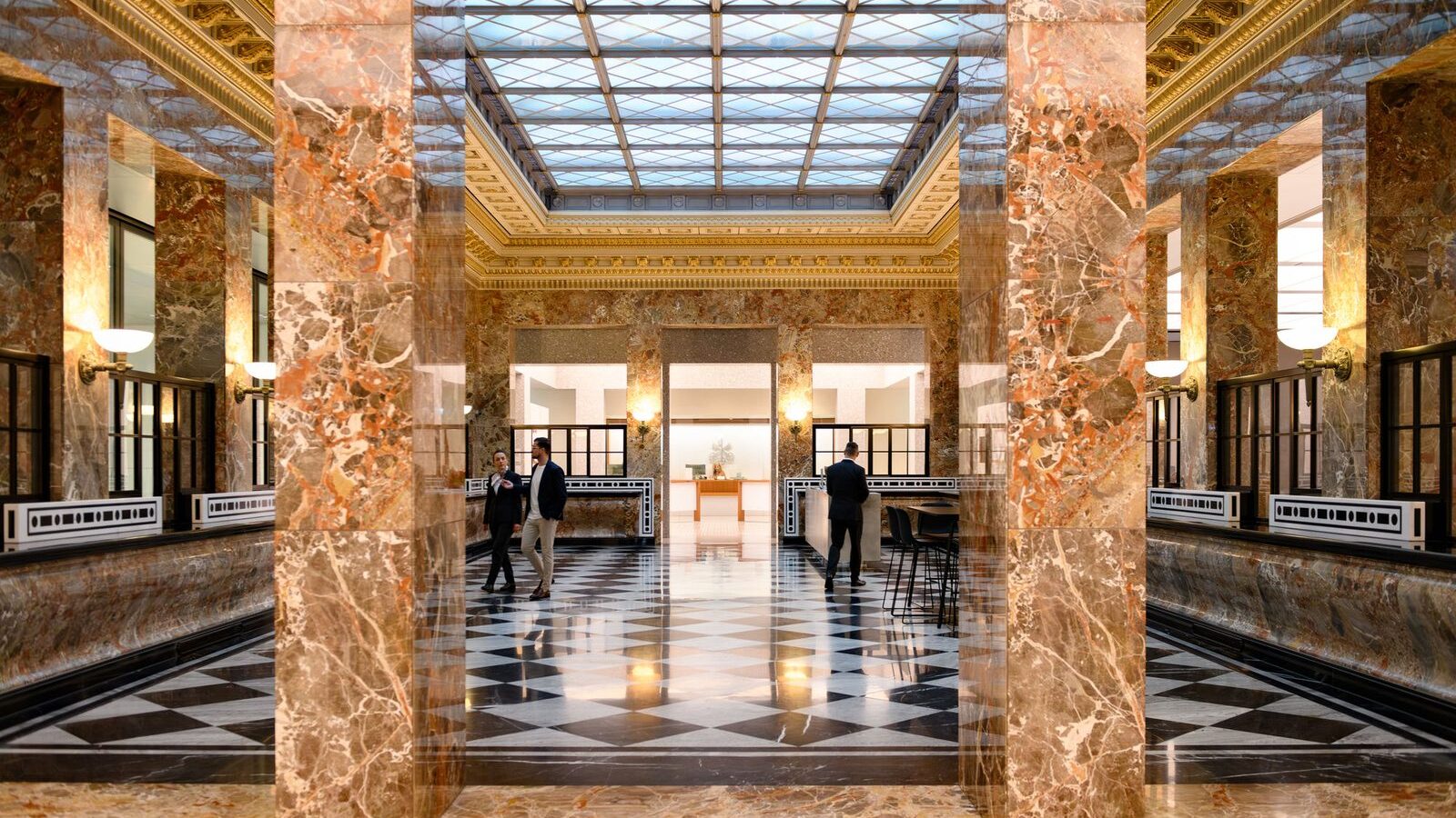 A UBS banking hall with marble columns and a glazed ceiling