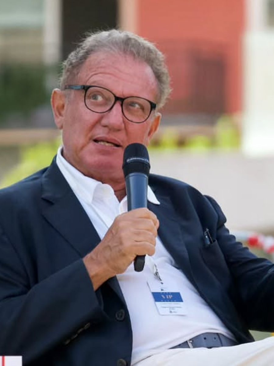 Antonio Di Bella, journalist, on stage with a microphone