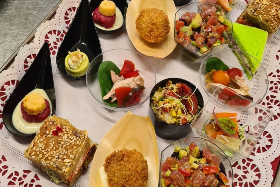 A tray of assorted finger food on a lace doily