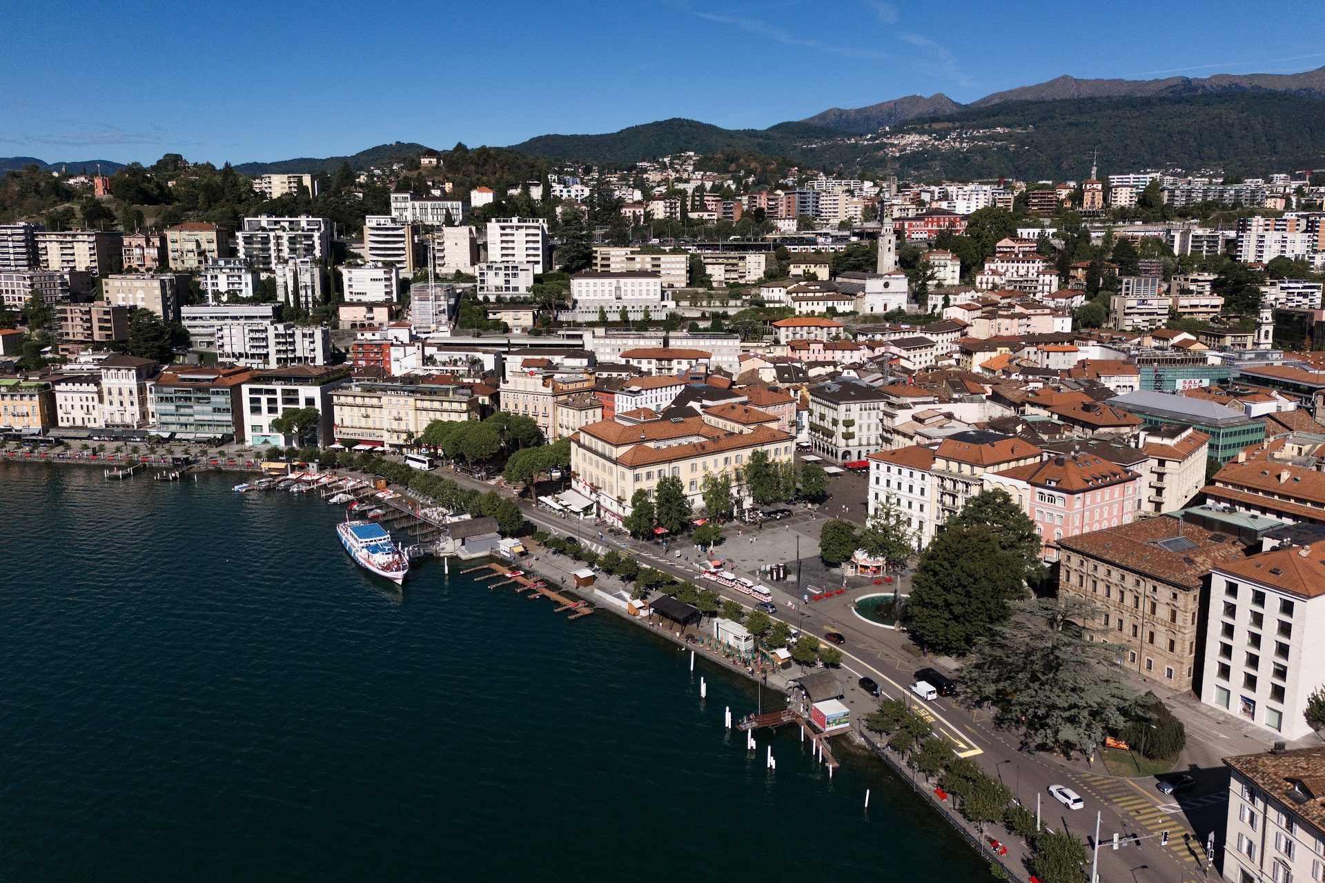Lugano seen from the lake: the waterfront, Piazza Riforma and the hills behind the city